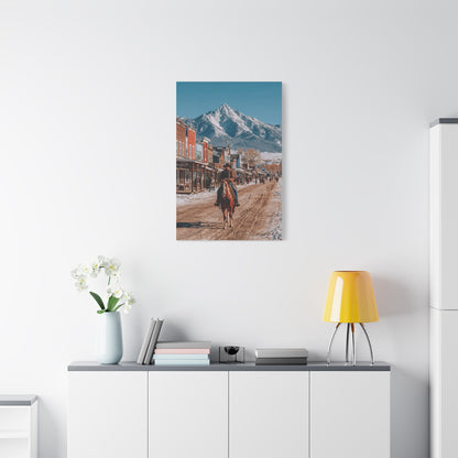 Cowboy Riding Through a Frontier Mountain Town Wall Art & Canvas Print